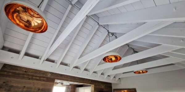 Photo of white timber ceiling with chrome lamps