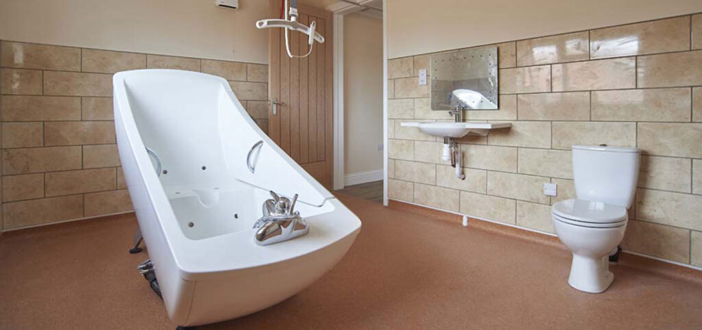 Image of disability adapted wetroom with hydrobath and ceiling hoists