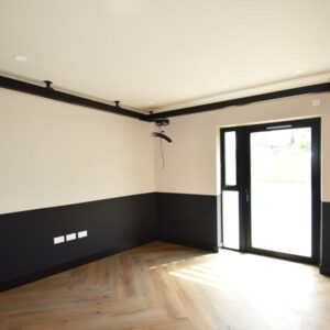 Bright and spacious therapy room with full ceiling hoist system to help carers lift and move.