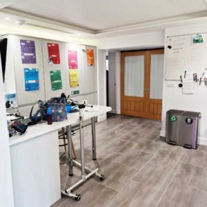 Modern accessible kitchen area with workspaces and whiteboard for carers.