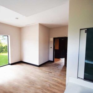 Bright and spacious therapy room with full ceiling hoist system to help carers lift and move.