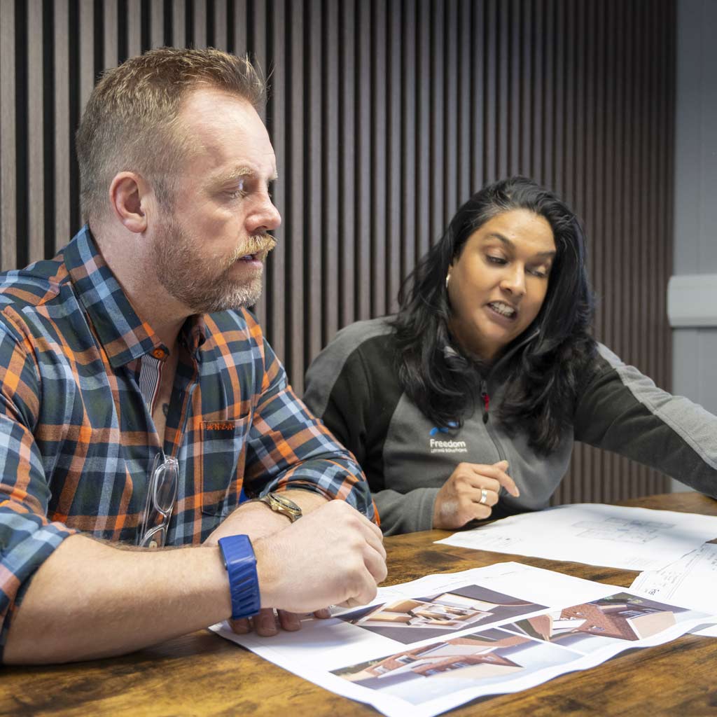 Image of two Freedom desgn team members reviewing a drawing of an accessible home.
